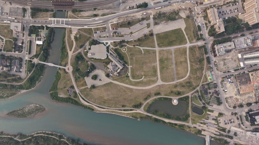 Aerial drone photo of The Confluence Historic Site & Parkland showing the river confluence, walking trails, and green space